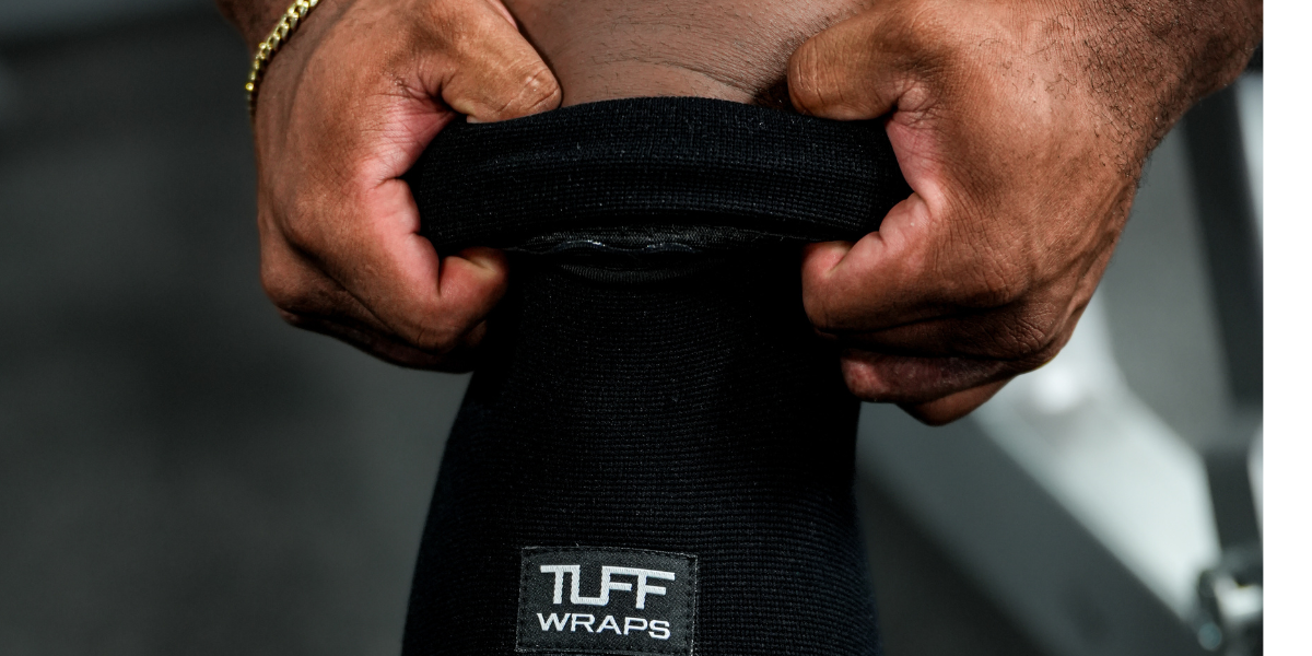man putting on knee sleeves for deadlift