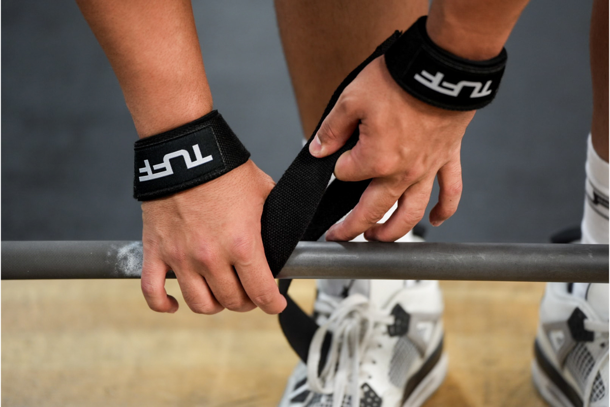 man putting on lifting straps